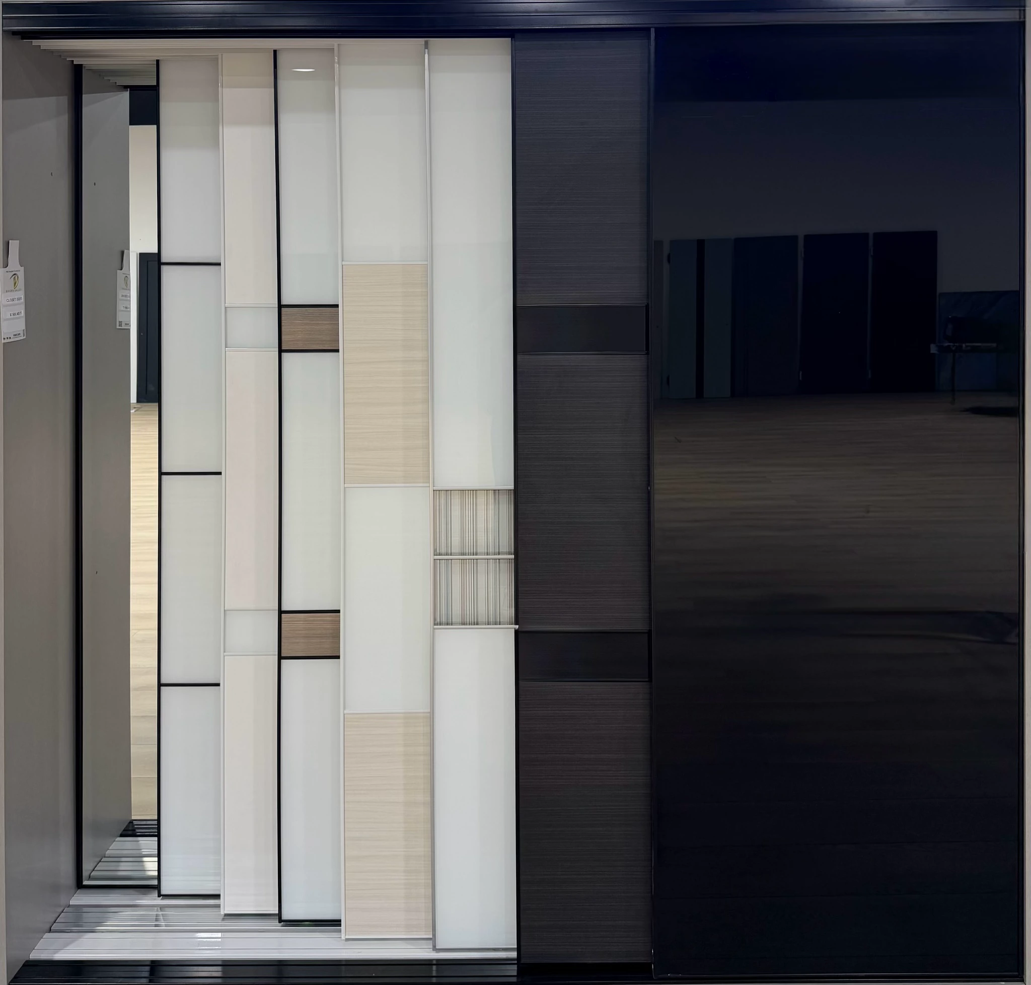 Tall custom sliding closet door display in black and white finishes
